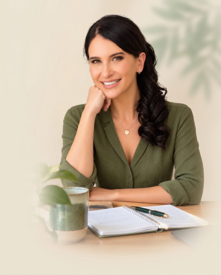 Alena at her desk, smiling as she reviews your care